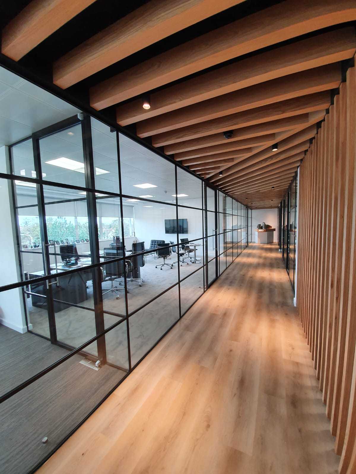 office hall with a glass partition wall combined with natural wood elements